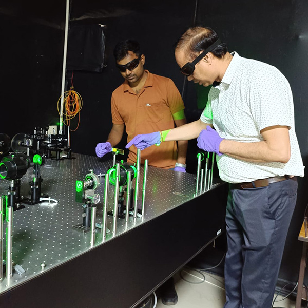 Raj Kumar (right) and Kamlesh Kumar (technical staff) are pictured with the optical setup.