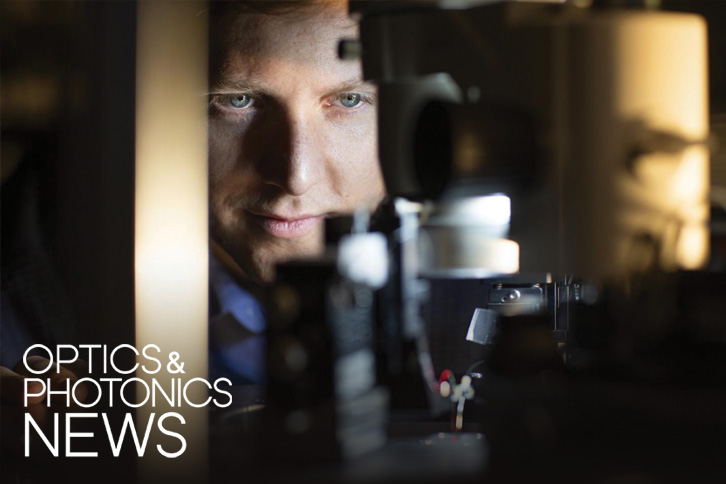 man looking at scientific device