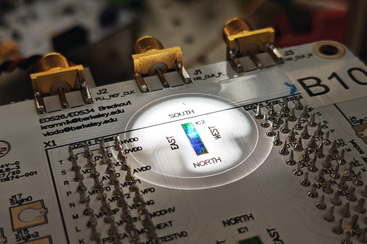 Packaged circuit board containing the chip placed under a microscope.